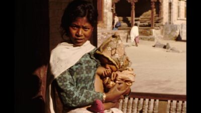 Nepal 1960s, View of woman breast feeding her child in outside
