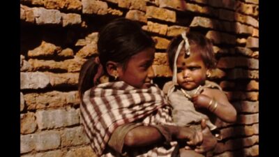 Nepal 1970s, A girl carrying her sister and standing in outside
