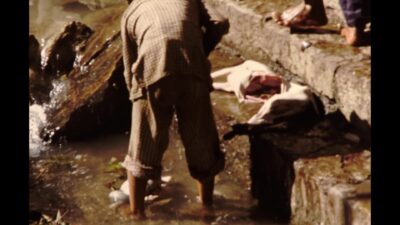 Nepal 1970s, Group of people washing an animal and boiling it