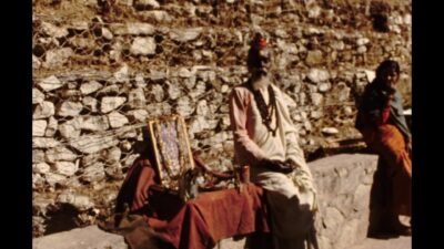 Nepal 1970s, A religious person sitting beside a photo frame during daytime
