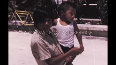 Mexico 1970s, Man standing and carrying a baby in outdoor