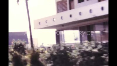 Mexico 1970s, Area view with buildings and trees from running car