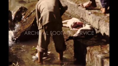 Nepal 1970s, Group of people washing an animal and boiling it