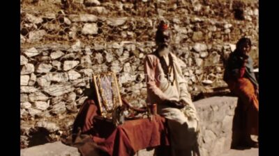 Nepal 1970s, A religious person sitting beside a photo frame during daytime