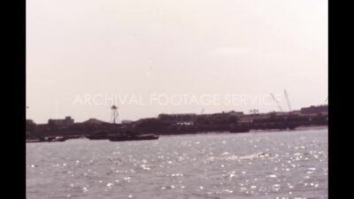 China 1980s, Boat moving in river close to town during daytime