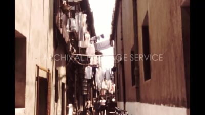 China 1980s, People walking in street between two houses