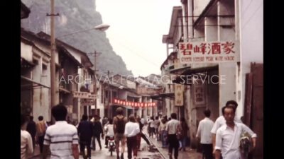 China 1980s, Movement of people in street between shop