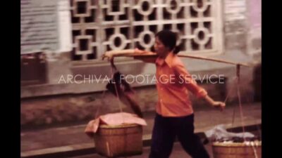 China 1980s, Woman carrying her belongings through street