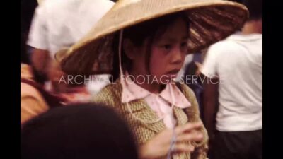 China 1980s, Girl carrying her sister in back in front of bus