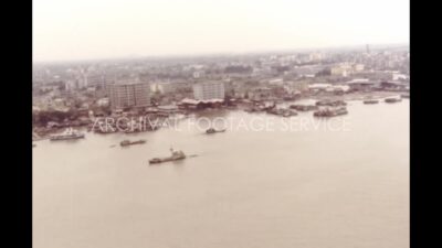 China 1980s, Aerial view of river with ship close to town during daytime