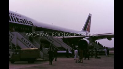 Italy 1970s, People getting up in aeroplane in port
